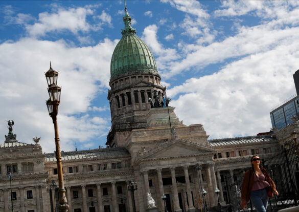 A pedestrian walks in front of the National Congress, as Argentines struggle amid rising inflation, in Buenos Aires, Argentina May 11, 2023. REUTERS/Agustin Marcarian
