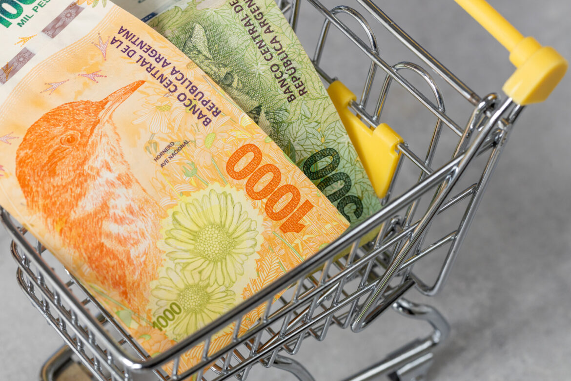 Financial concept, Argentina inflation rate, store prices, Empty shopping cart and Argentine pesos money