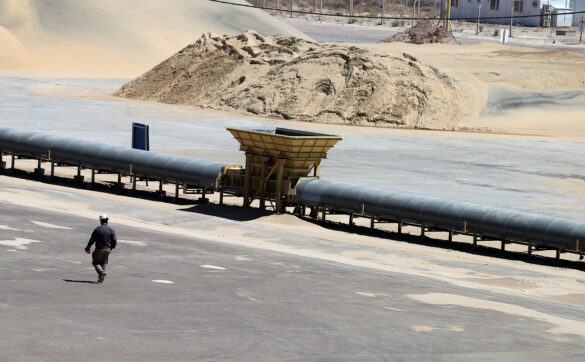 A worker walks near a pile of sand at Vaca Muerta shale oil and gas drilling, in the Patagonian province of Neuquen, Argentina January 21, 2019. Picture taken January 21, 2019. REUTERS/Agustin Marcarian