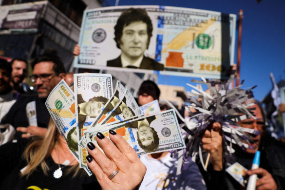 FILE PHOTO: Supporters of Argentine presidential candidate Javier Milei hold dollar bills with his face on them, during a campaign rally, in Buenos Aires, Argentina September 25, 2023. REUTERS/Cristina Sille//File Photo