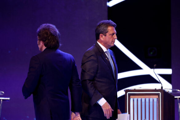 FILE PHOTO: Argentina Presidential candidate Sergio Massa of Union por la Patria party and Javier Milei of La Libertad Avanza party walk past each other during the presidential debate ahead of the October 22 general elections, at the National University of Santiago del Estero, in Santiago del Estero, Argentina October 1, 2023. Tomas Cuesta/Pool via REUTERS/File Photo