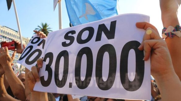 Argentina Human rights group HIJOS member holds up a sign reading "They are 30,000" in reference to the victims of the last dictatorship. Photo: HIJOS