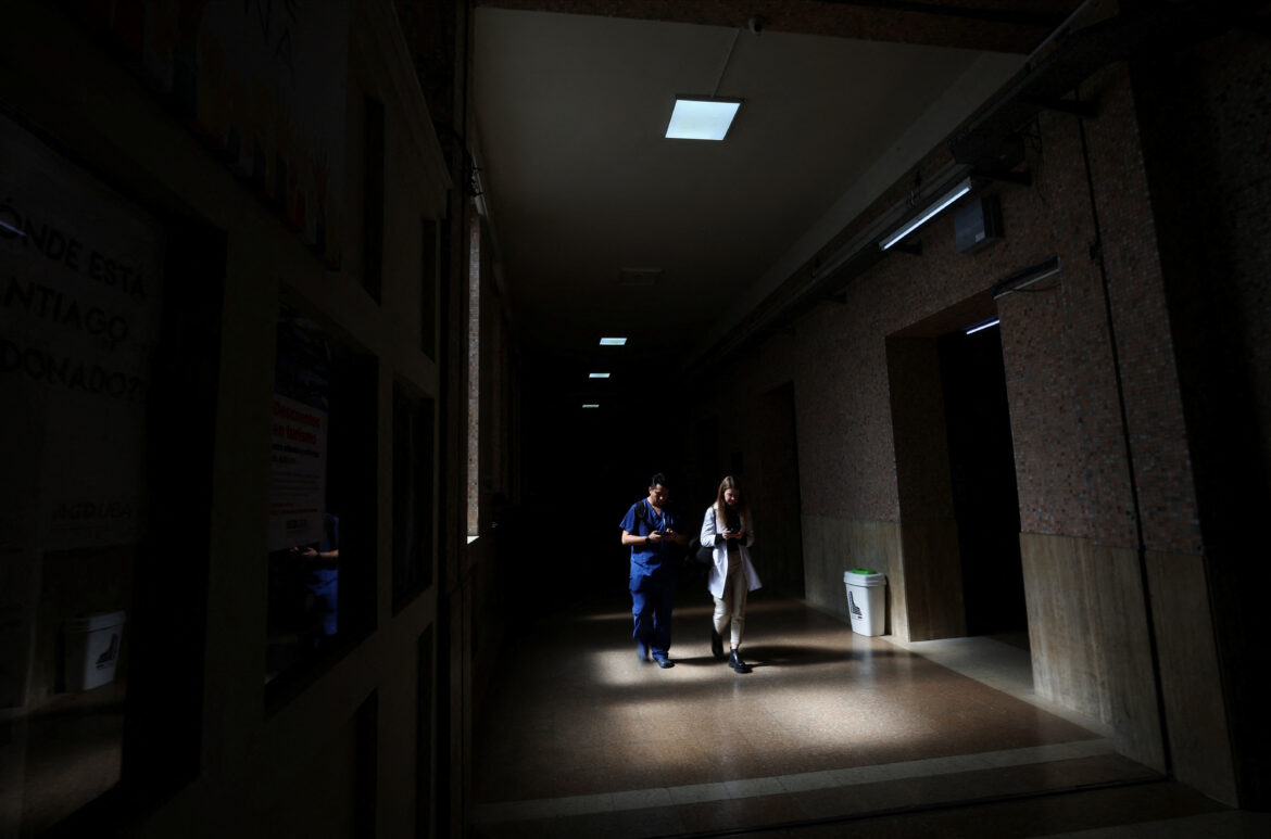 Medical students walk in a hallway of the University of Buenos Aires Medical School in the dark, as the university has to restrict the use of electricity due to budget cuts, in the run-up to a national strike on April 23 against Argentina's President Javier Milei's policy of cuts in public education, in Buenos Aires, Argentina April 17, 2024. REUTERS/Agustin Marcarian