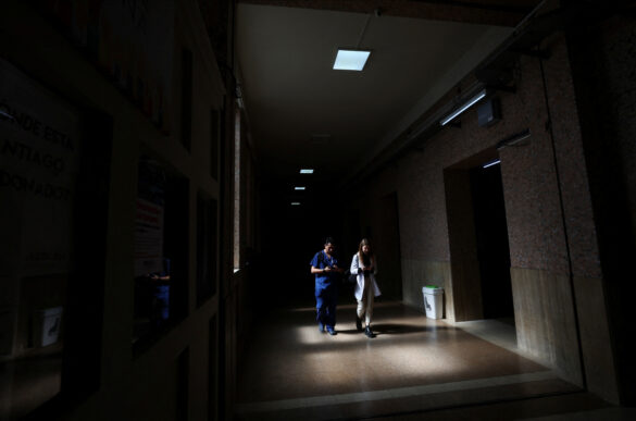 Medical students walk in a hallway of the University of Buenos Aires Medical School in the dark, as the university has to restrict the use of electricity due to budget cuts, in the run-up to a national strike on April 23 against Argentina's President Javier Milei's policy of cuts in public education, in Buenos Aires, Argentina April 17, 2024. REUTERS/Agustin Marcarian