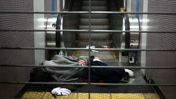 A homeless person sleeps near the escalator of a subway station, in Buenos Aires, Argentina, May 30, 2024. REUTERS/Tomas Cuesta