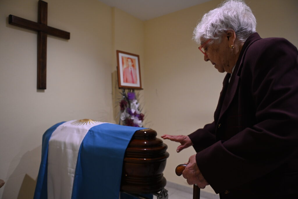 A woman pays her respects at Benito Romano's wake. Credit: courtesy of the Argentine Forensic Anthropology Team