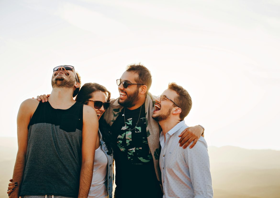 Happiness stock image. Four happy people in Brazil. Photo: Helena Lopes via Pexels.