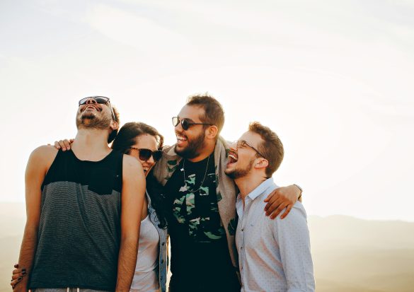 Happiness stock image. Four happy people in Brazil. Photo: Helena Lopes via Pexels.
